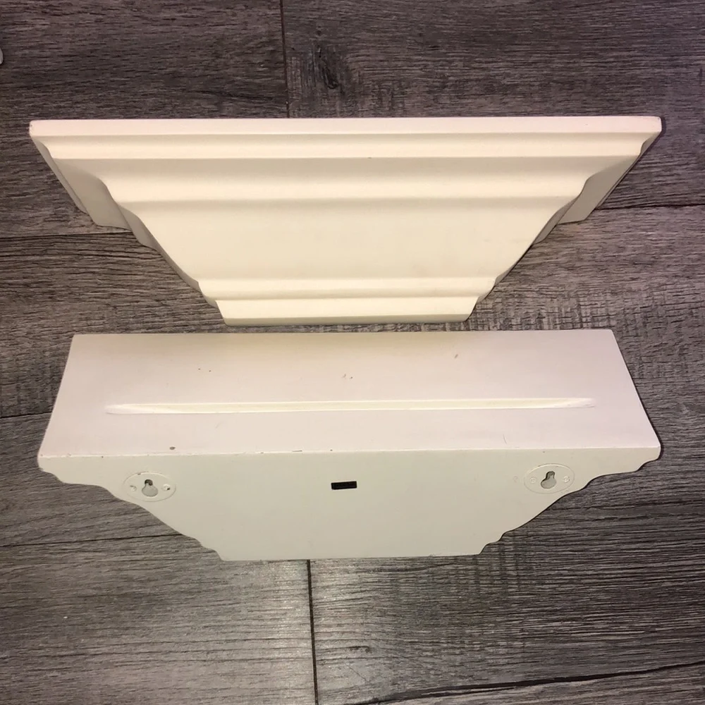 Four all white shelves with some light little scratches